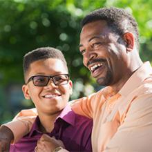Son with glasses and his father